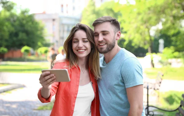 Felice giovane coppia prendendo selfie nel parco — Foto Stock