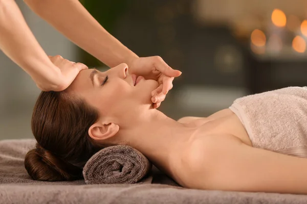 Mooie jonge vrouw genieten van massage in spa salon — Stockfoto