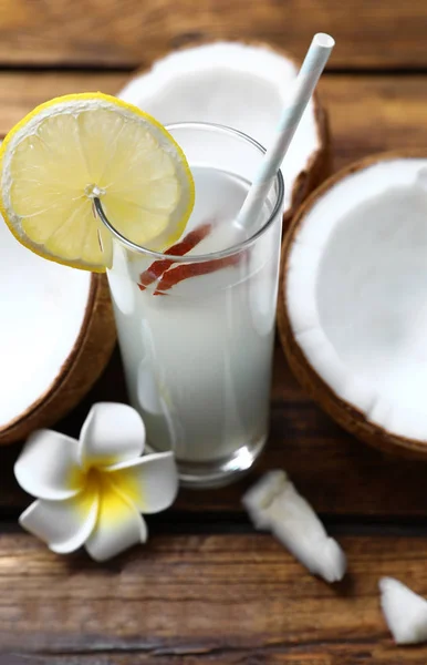 Composición con vaso de agua de coco y limón sobre mesa de madera, primer plano — Foto de Stock