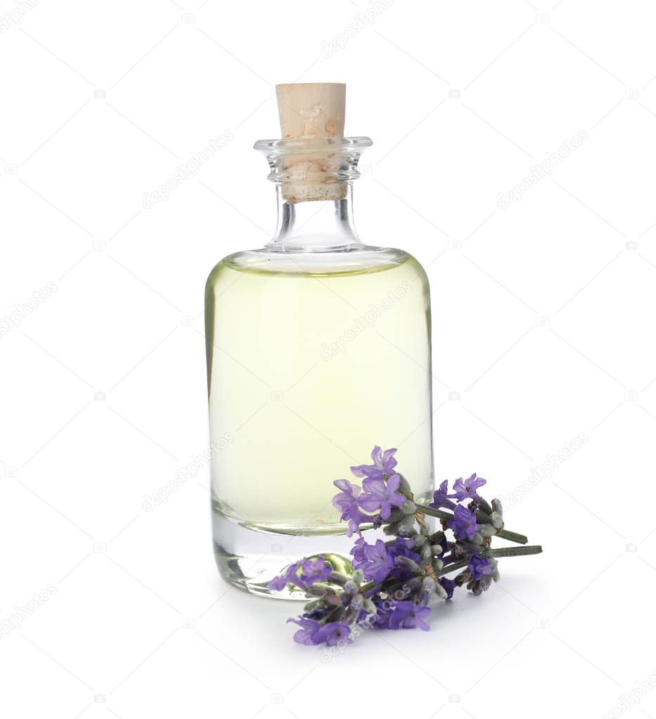 Bottle with natural lavender oil and flowers on white background