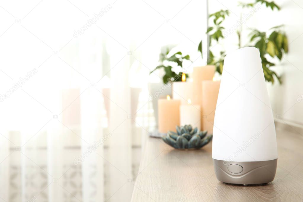 Composition with modern aroma humidifier on wooden shelf indoors, space for text