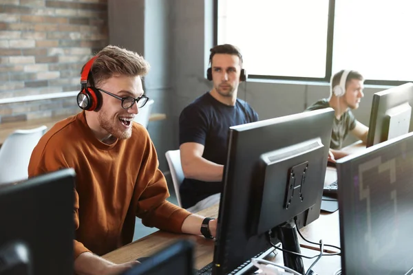 Hombres jugando videojuegos en internet café —  Fotos de Stock