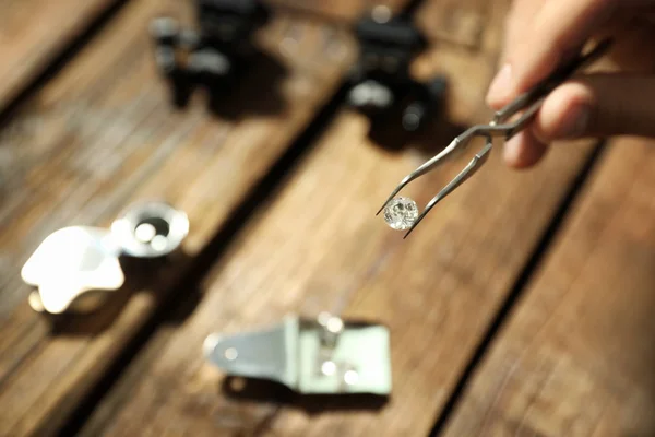 Mannelijke juwelier evalueren van kostbare edelstenen aan tafel in workshop, close-up — Stockfoto