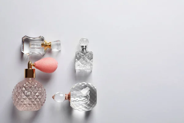 Composición plana con frascos de perfume y espacio para texto sobre fondo gris —  Fotos de Stock