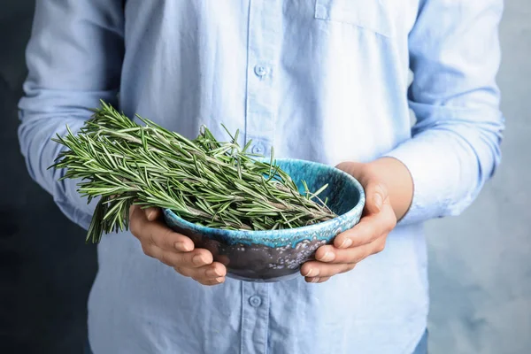 Young woman holding bowl of fresh rosemary, closeup — Stock Photo, Image
