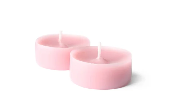 Małe różowe świece woskowe na białym tle — Zdjęcie stockowe