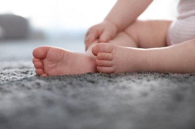 Gri halı kapalı oturma ile Barefoot küçük çocuk, kapatmak