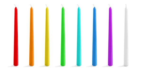 Conjunto com diferentes velas de cera decorativa no fundo branco — Fotografia de Stock