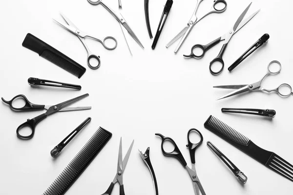 Frame made of scissors and other hairdresser's accessories on white background, top view. Space for text — Stock Photo, Image