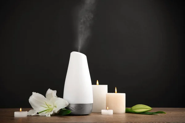 Composition with aroma humidifier on table against black background. Space for text — Stock Photo, Image