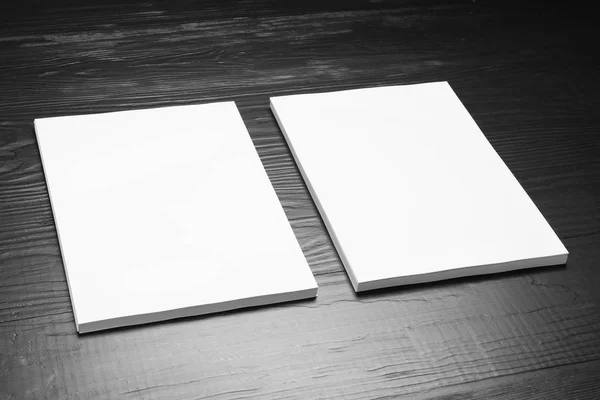 Blank paper sheets for brochure on black wooden background. Mock up — Stock Photo, Image