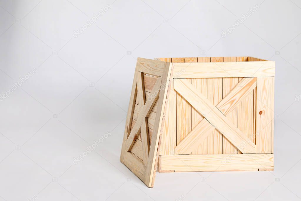 Open wooden crate on grey background. Space for text