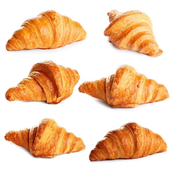 Set di deliziosi croissant appena sfornati su sfondo bianco. Pasticceria francese — Foto Stock