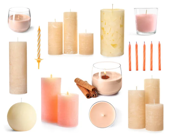 Set con diverse candele di cera decorativa su sfondo bianco — Foto Stock