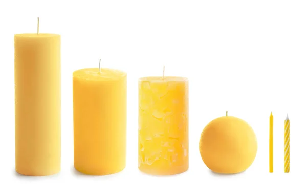 Set with different yellow candles on white background — Stock Photo, Image