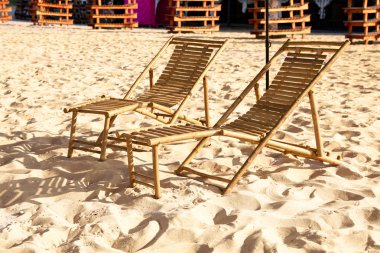 Güneşli bir gün boş ahşap şezlong ile kumlu plaj