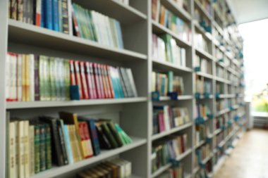 Kütüphanede kitap ile rafların bulanık görünümü