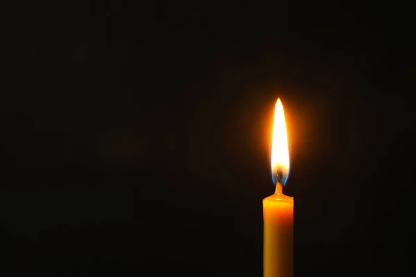 Burning candle on dark background, space for text. Symbol of sorrow — Stock Photo, Image