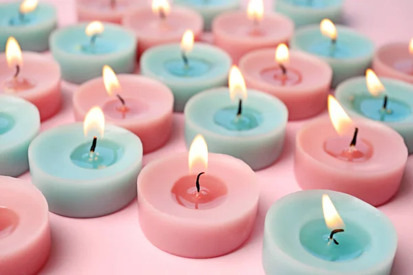 Burning colorful decorative candles on pink background, space for text — Stock Photo, Image