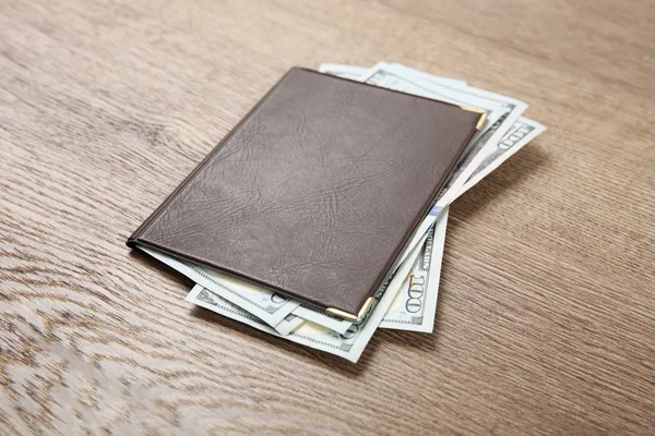 Pension certificate with American money on brown wooden background — Stock Photo, Image