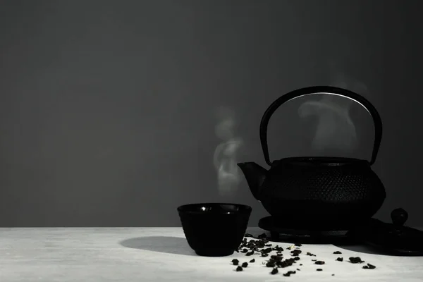 Oriental teapot and cup on table against grey background, space for text — Stock Photo, Image