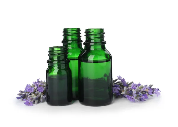 Bottles with natural lavender oil and flowers on white background — Stock Photo, Image