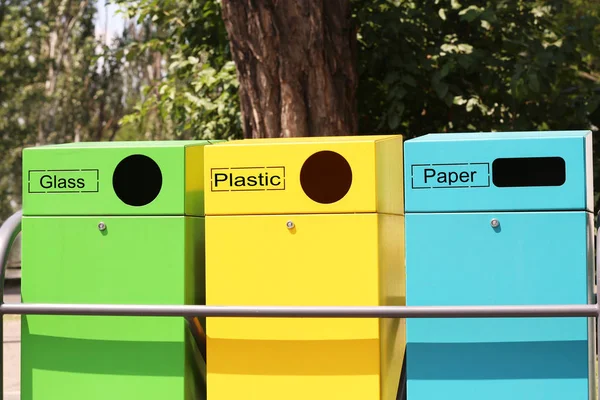 Waste sorting bins on city street. Recycling concept