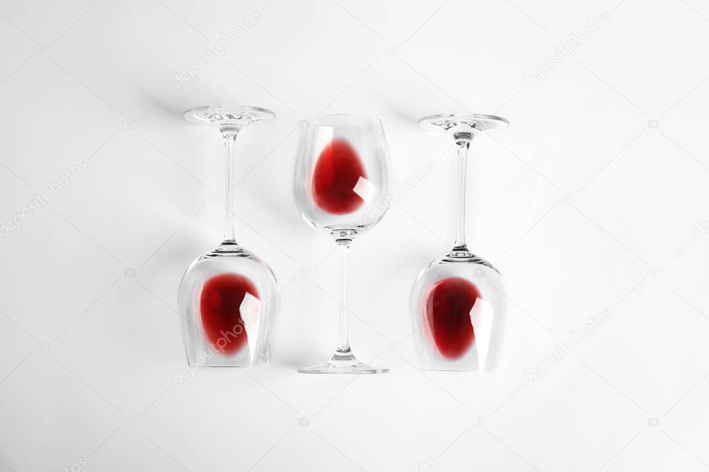 Composition with glasses of wine on white background, top view