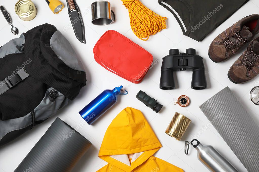 Flat lay composition with different camping equipment on white background