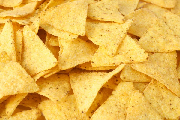 Tasty Mexican nachos chips as background, closeup — Stock Photo, Image