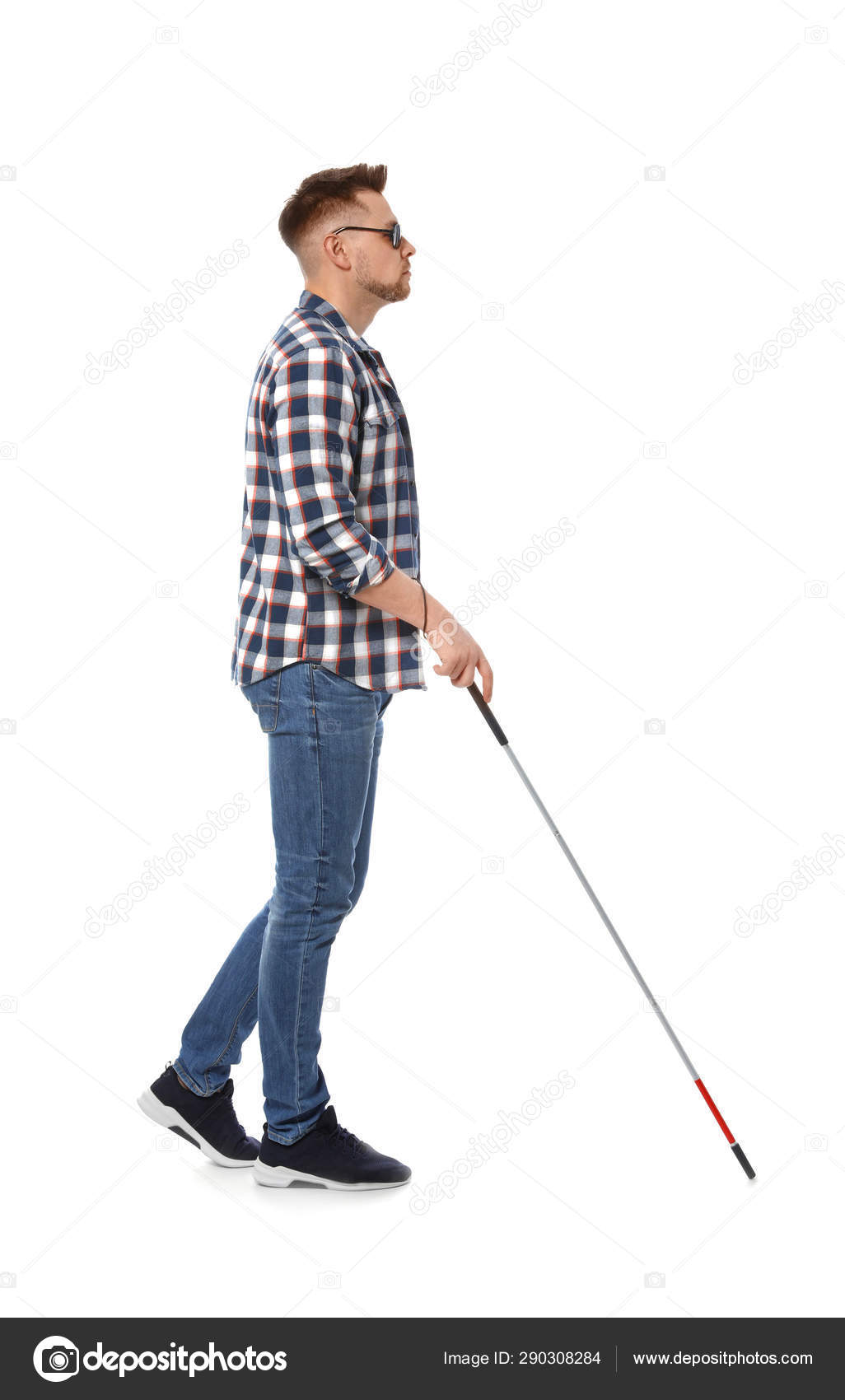 Blind man in dark glasses with walking cane on white background