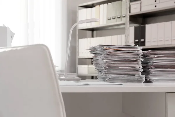 Stacks of documents on table in office