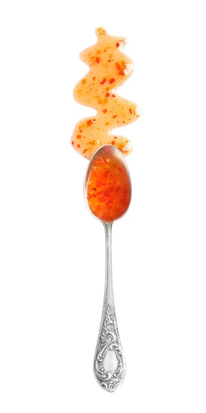 Delicious sweet chili sauce and spoon on white background, top view — Stock Photo, Image