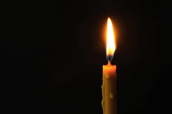 Burning candle on dark background, space for text. Symbol of sorrow — Stock Photo, Image