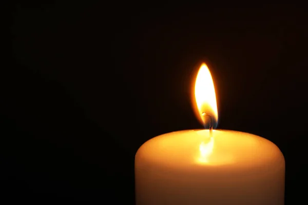 Burning candle on dark background, closeup with space for text. Symbol of sorrow — Stock Photo, Image