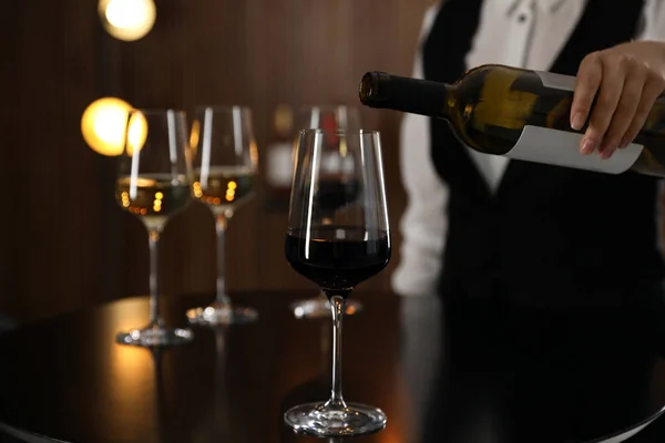 stock image Waitress pouring wine into glass in restaurant, closeup