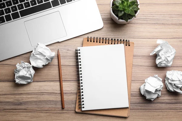 Flat lay composition with notebook and crumpled paper on wooden table. Space for text — Stock Photo, Image