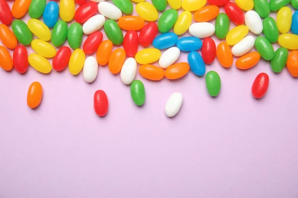 Flat lay composition with jelly beans on color background. Space for text — Stock Photo, Image