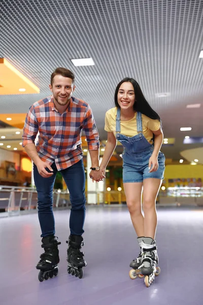 Young couple spending time at roller skating rink — Stock Photo, Image