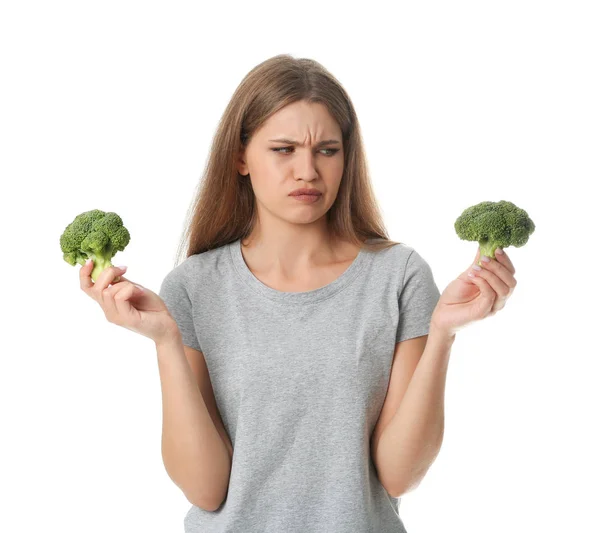 Portrait of unhappy woman with broccoli on white background — Stock Photo, Image