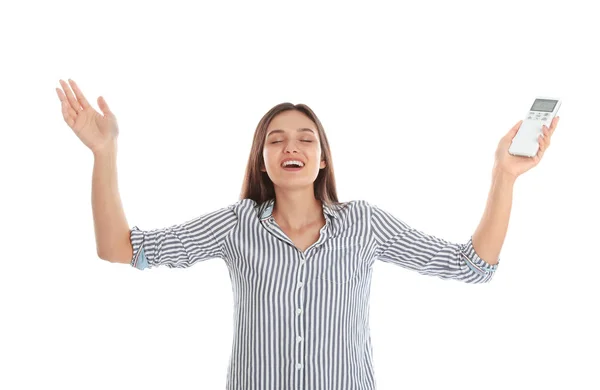 Jovem feliz com ar condicionado controle remoto no fundo branco — Fotografia de Stock