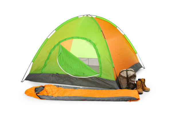 Comfortable colorful camping tent with sleeping bag and boots on white background