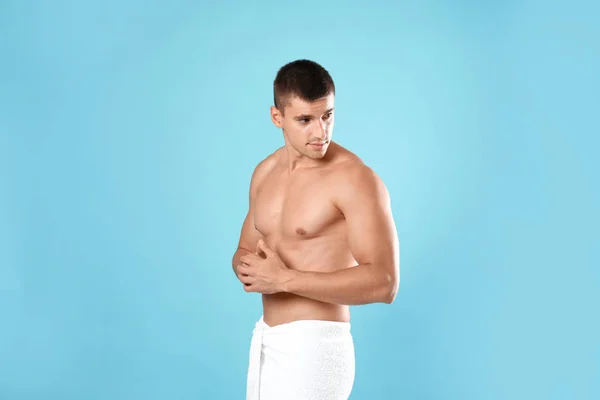 Jonge man met slank lichaam op licht blauwe achtergrond — Stockfoto
