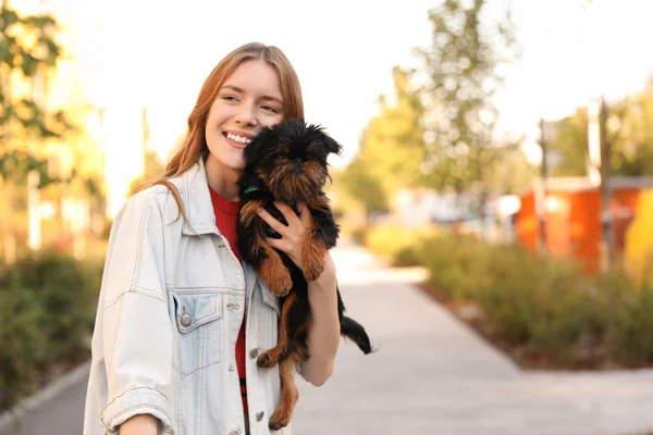 Young woman with adorable Brussels Griffon dog in park. Space for text — Stock Photo, Image