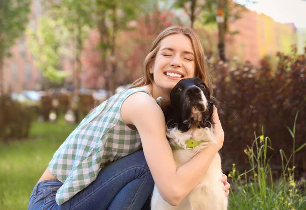 Jeune femme étreignant son chien espagnol Springer anglais à l'extérieur — Photo