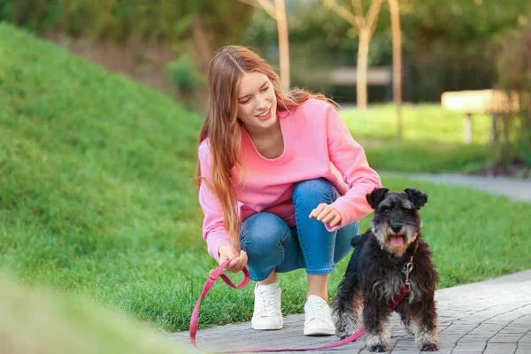 Young woman with Miniature Schnauzer dog in park — Stock Photo, Image