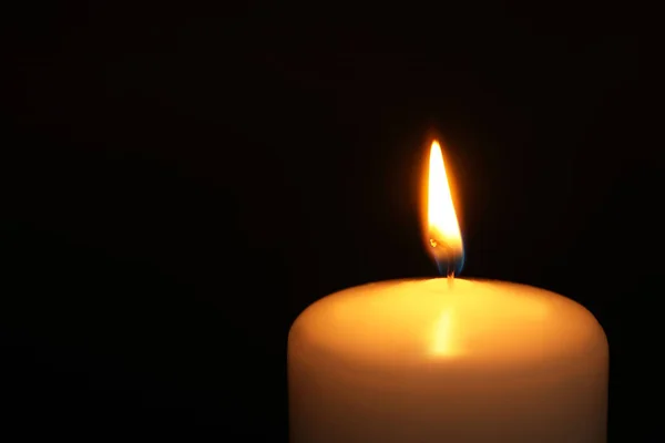 Burning candle on dark background, closeup with space for text. Symbol of sorrow — Stock Photo, Image