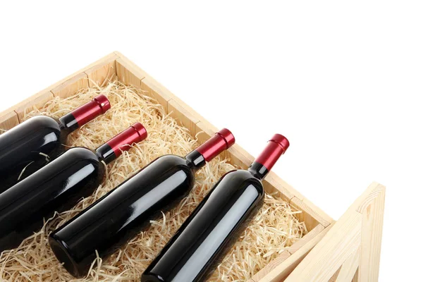 Botellas de vino en cajón de madera abierto aislado en blanco —  Fotos de Stock