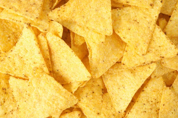 Tasty Mexican nachos chips as background, top view — Stock Photo, Image