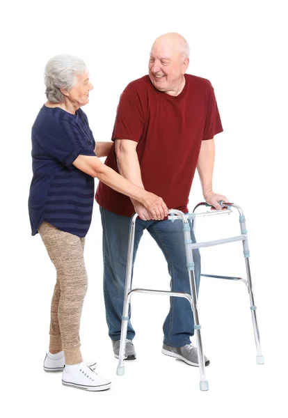 Mulher idosa ajudando seu marido com uma moldura no fundo branco — Fotografia de Stock